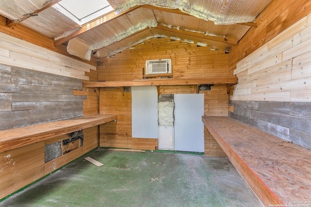 storage area featuring an AC wall unit and a skylight