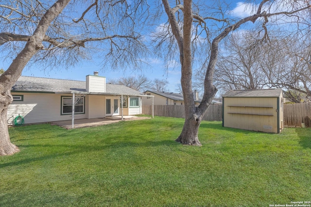 view of yard with a patio and a storage unit