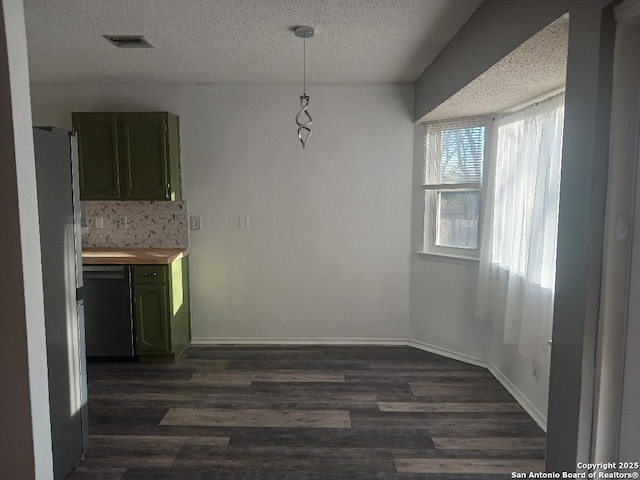 unfurnished dining area with dark hardwood / wood-style floors and a textured ceiling