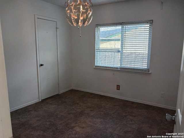 empty room with an inviting chandelier