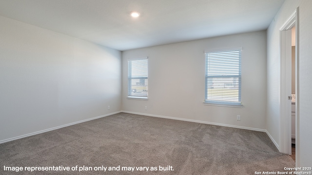 carpeted spare room featuring a healthy amount of sunlight