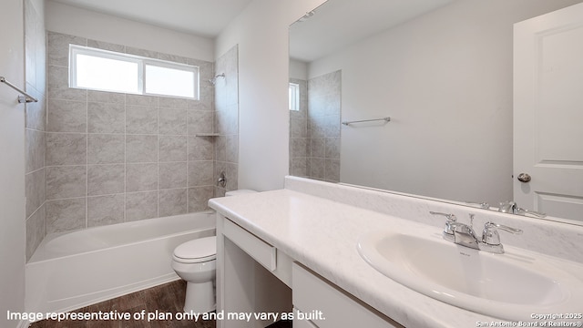 full bathroom with wood-type flooring, vanity, toilet, and tiled shower / bath