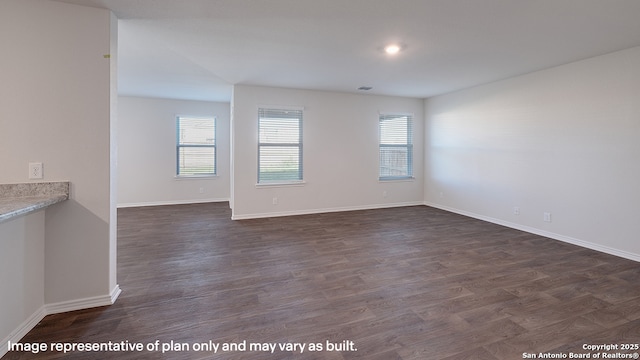 unfurnished room with dark hardwood / wood-style flooring