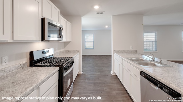 kitchen featuring white cabinets, plenty of natural light, sink, and appliances with stainless steel finishes