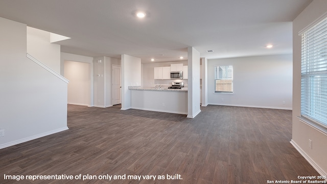 unfurnished living room with dark hardwood / wood-style floors