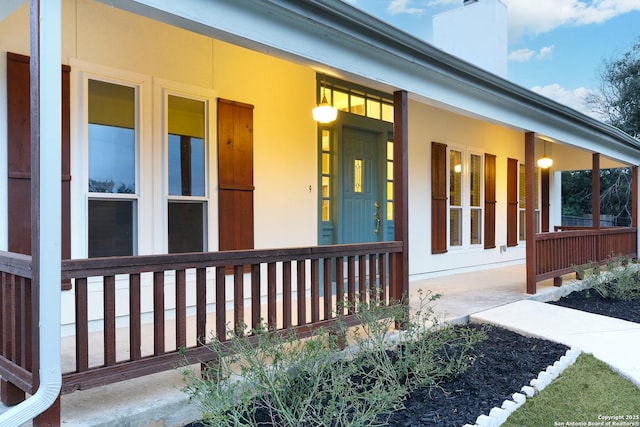 view of exterior entry featuring a porch