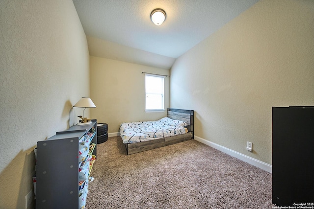 carpeted bedroom with vaulted ceiling