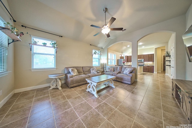 living room featuring tile patterned flooring, vaulted ceiling, and ceiling fan