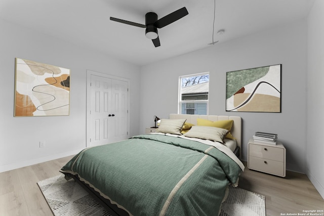 bedroom featuring light hardwood / wood-style floors, a closet, and ceiling fan