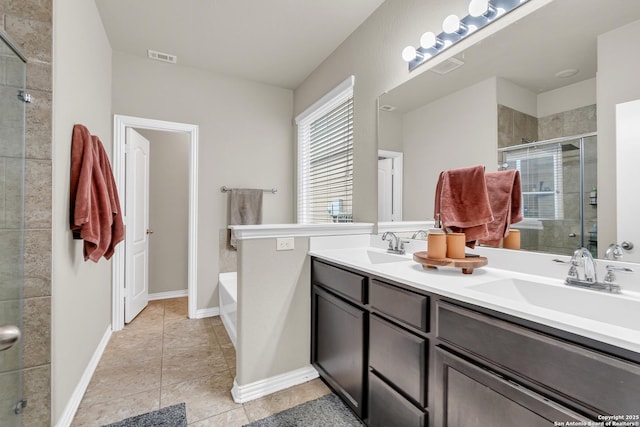 bathroom featuring tile patterned flooring, vanity, and shower with separate bathtub