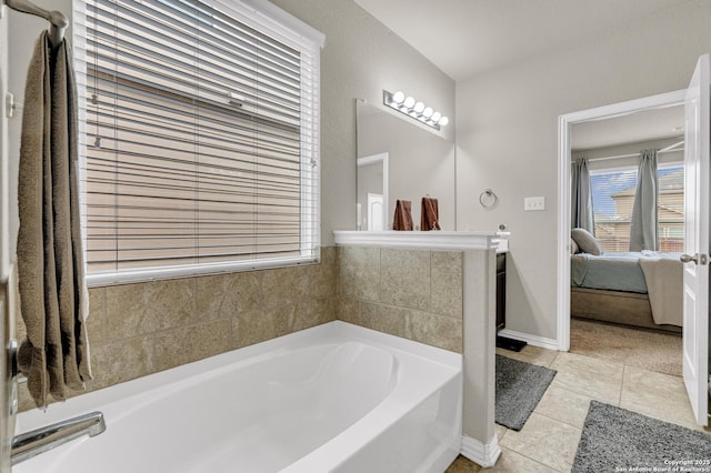 bathroom with tile patterned floors and a tub