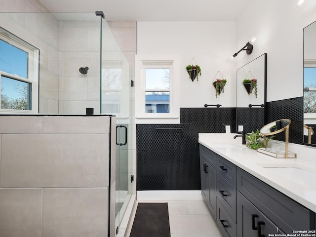 bathroom featuring tile walls, an enclosed shower, tile patterned floors, and vanity