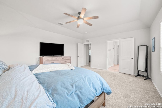 carpeted bedroom featuring ceiling fan, a raised ceiling, and lofted ceiling