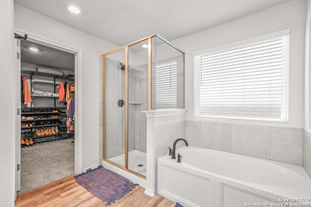 bathroom featuring independent shower and bath