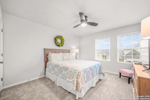 bedroom featuring light carpet and ceiling fan