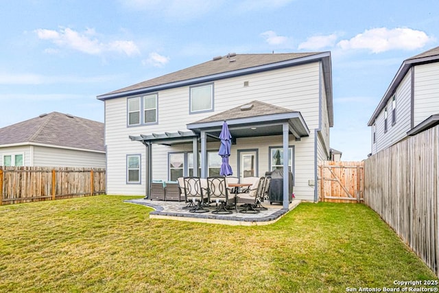 rear view of house featuring a lawn, an outdoor living space, and a patio area