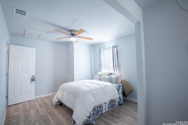 bedroom with ceiling fan and light hardwood / wood-style floors