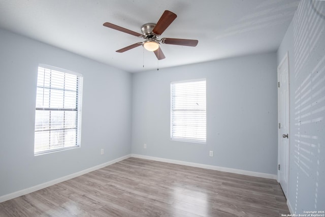 spare room featuring light hardwood / wood-style flooring, plenty of natural light, and ceiling fan