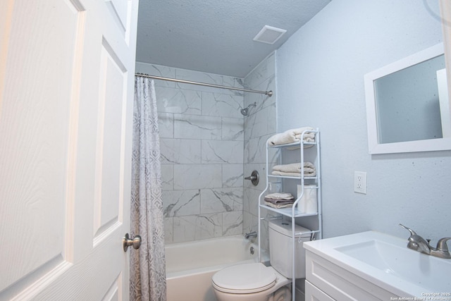 full bathroom featuring vanity, toilet, shower / bath combo with shower curtain, and a textured ceiling