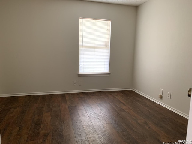 unfurnished room featuring dark hardwood / wood-style flooring