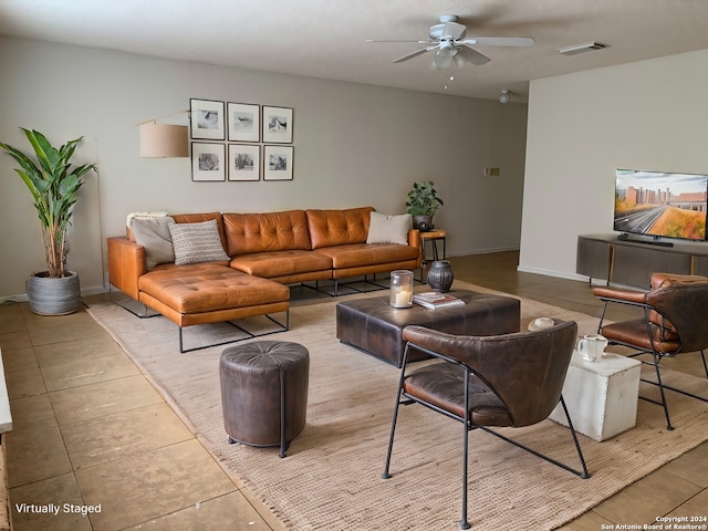 living room featuring ceiling fan and light tile patterned flooring