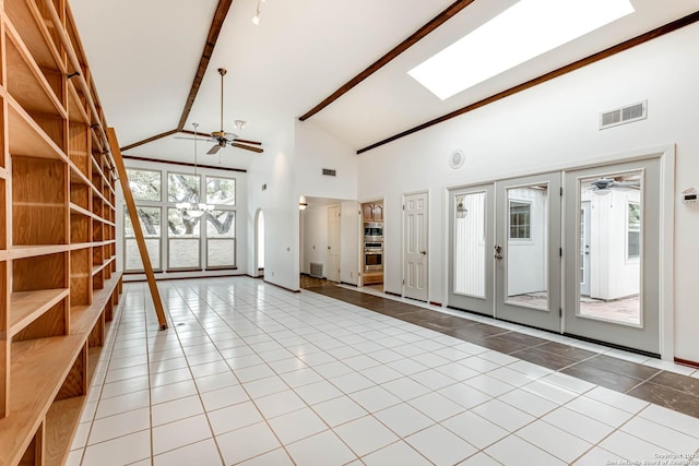 interior space with high vaulted ceiling, french doors, a skylight, ceiling fan, and beam ceiling