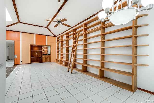 unfurnished living room featuring ceiling fan, light tile patterned flooring, ornamental molding, and vaulted ceiling