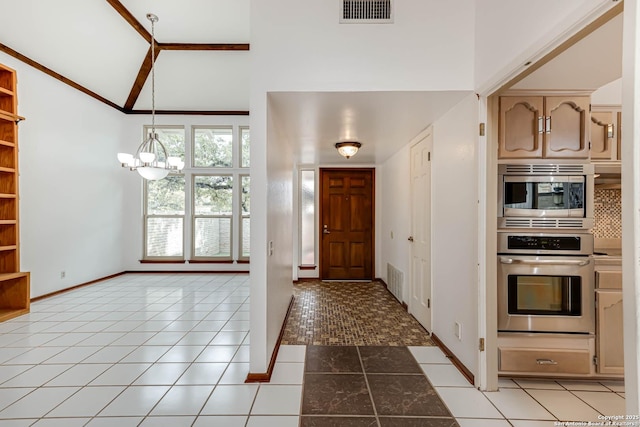 entryway with light tile patterned floors, high vaulted ceiling, and a notable chandelier