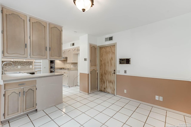 kitchen featuring sink, light tile patterned floors, light brown cabinetry, tasteful backsplash, and gas cooktop