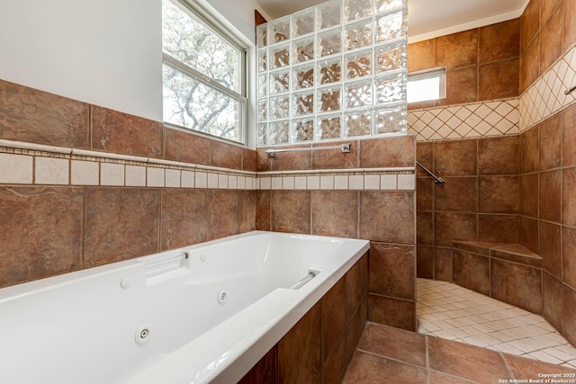 bathroom featuring tile patterned flooring and independent shower and bath