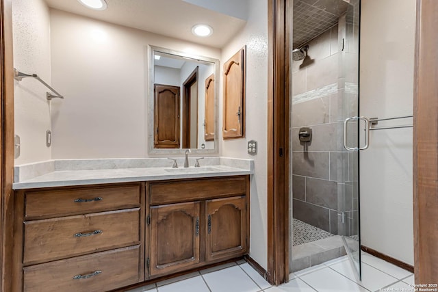 bathroom featuring tile patterned floors, vanity, and an enclosed shower