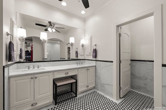 bathroom with vanity, crown molding, ceiling fan, and tile walls