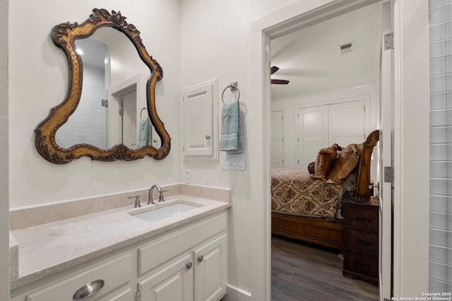 bathroom with ceiling fan, vanity, and wood-type flooring