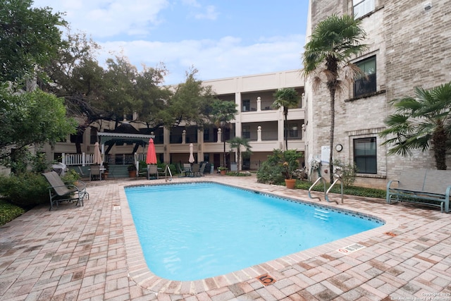 view of swimming pool featuring a patio area