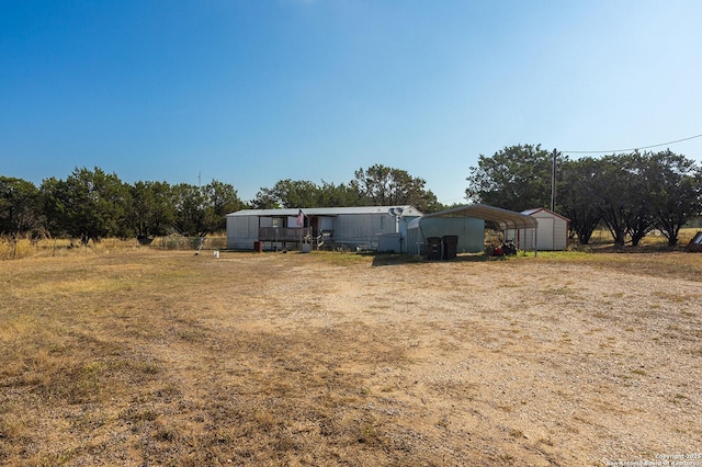 view of yard featuring a rural view and a carport