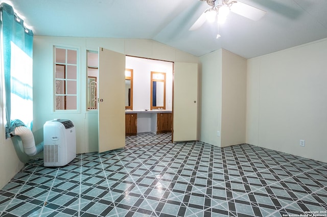 unfurnished room featuring ceiling fan and vaulted ceiling