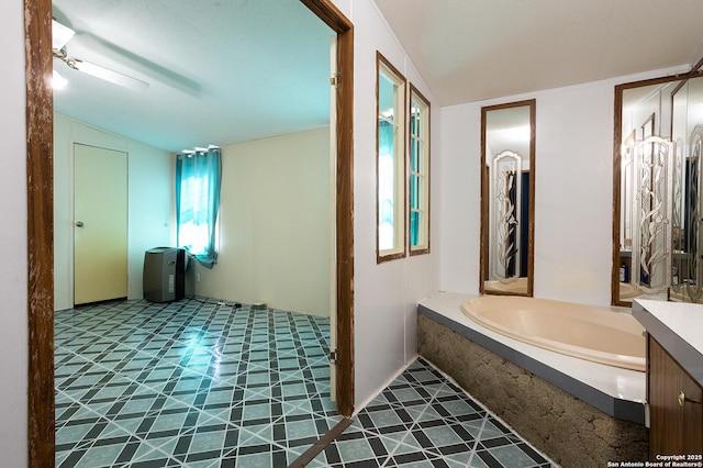 bathroom with vanity and a tub