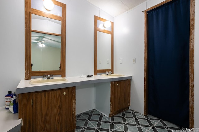 bathroom featuring a textured ceiling, vanity, vaulted ceiling, and ceiling fan