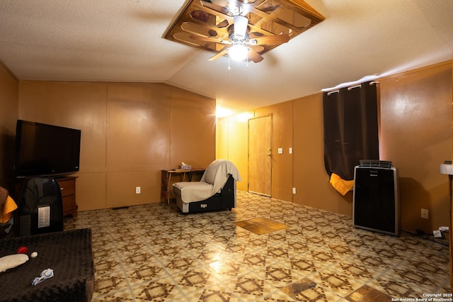 living area with vaulted ceiling and ceiling fan