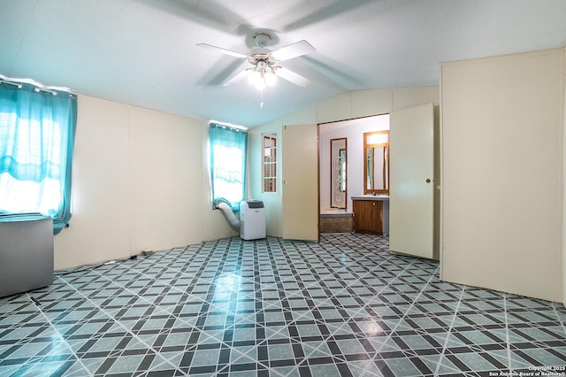 unfurnished room with ceiling fan, a textured ceiling, and vaulted ceiling