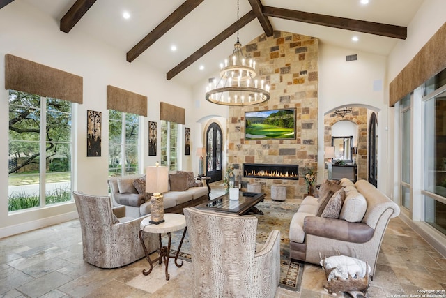 living room with arched walkways, high vaulted ceiling, a stone fireplace, stone tile floors, and beamed ceiling