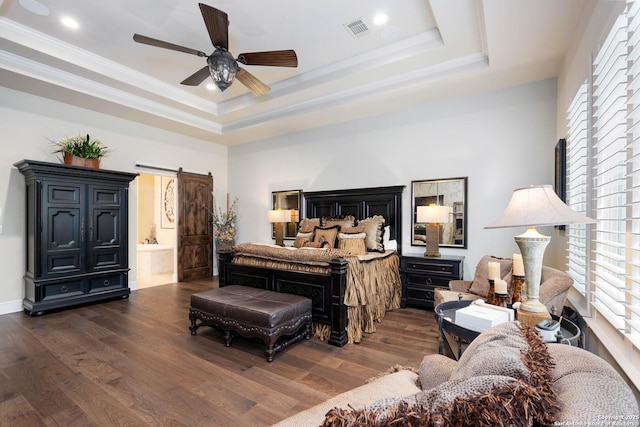 bedroom with dark wood-style flooring, a raised ceiling, and visible vents