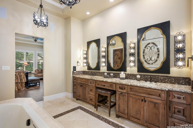 bathroom with double vanity, recessed lighting, a sink, and baseboards