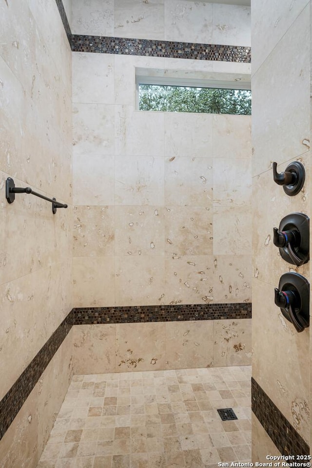 bathroom with a tile shower