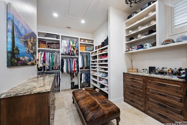 walk in closet with visible vents and attic access