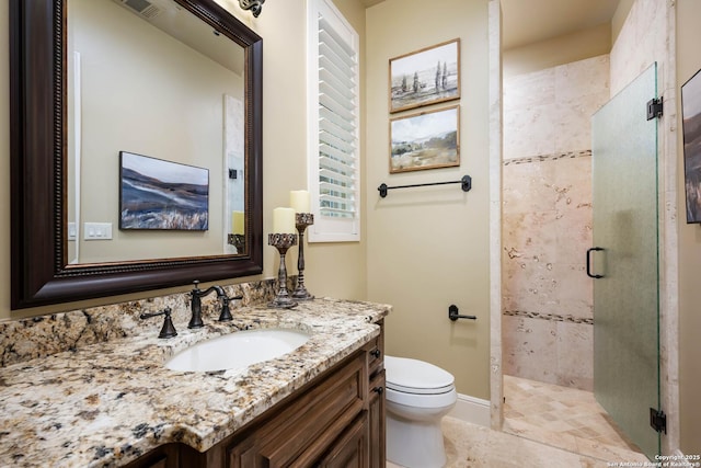 full bath featuring visible vents, toilet, a stall shower, vanity, and baseboards