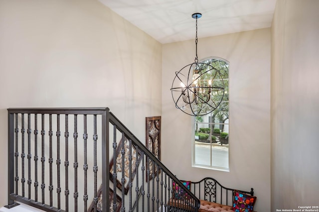 staircase featuring an inviting chandelier