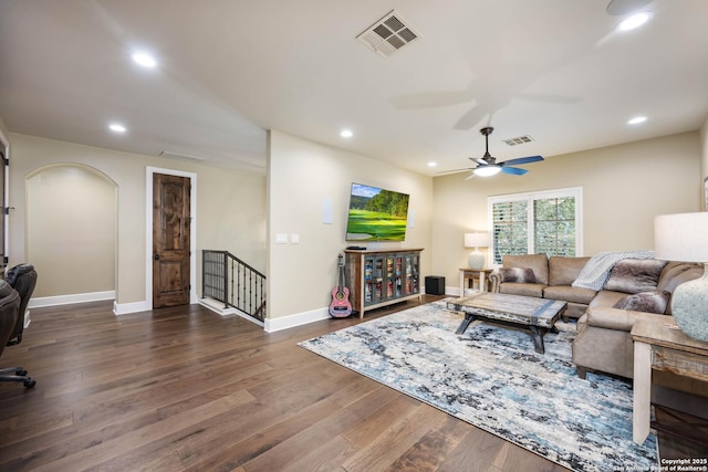 living room featuring dark wood finished floors, visible vents, and recessed lighting