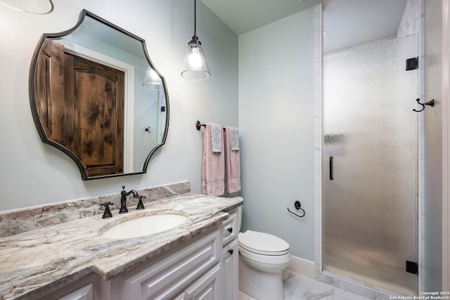 bathroom featuring marble finish floor, toilet, a shower stall, vanity, and baseboards