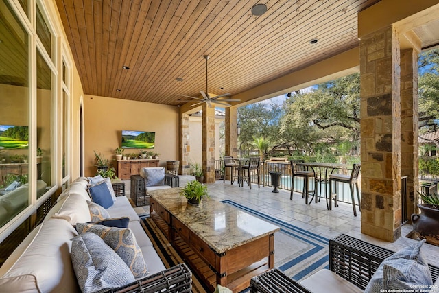 view of patio with ceiling fan, outdoor dry bar, and an outdoor living space